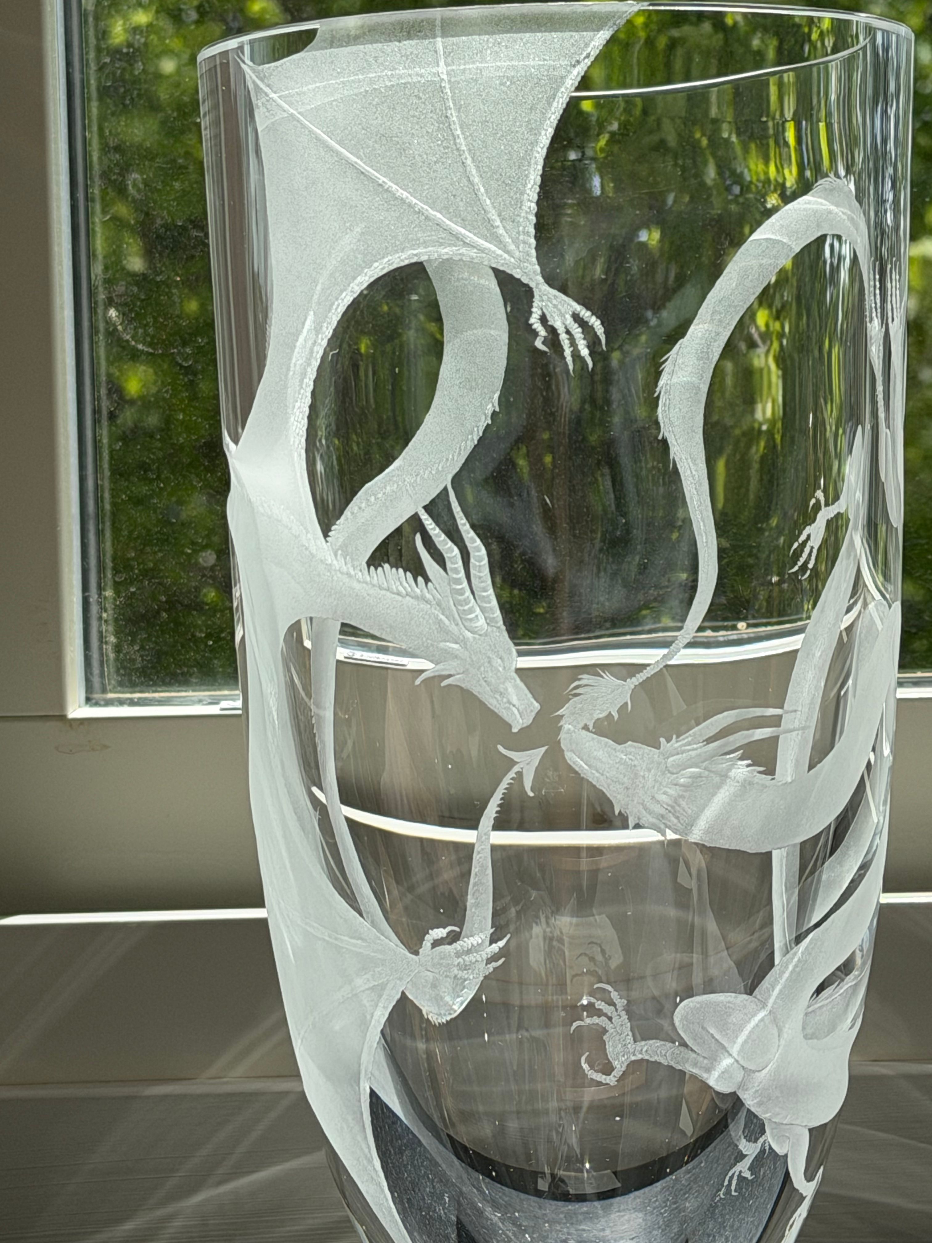 Dragons engraved around a clear glass cylinder